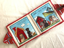 Load image into Gallery viewer, dog-themed soft book with illustrations of dogs and a red doghouse on a white surface.