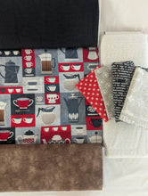 Load image into Gallery viewer, Fabric roll with coffee-themed pattern next to folded fabric pieces on a white background
