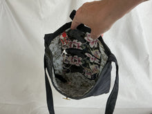 Load image into Gallery viewer, Interior of floral-patterned bag showing key fob and zipped pocket
