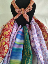 Load image into Gallery viewer, A display of various neck coolers made from different fabrics, tied in a knot, presented on a mannequin.
