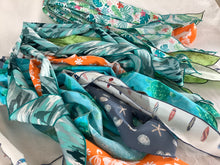 Load image into Gallery viewer, A selection of neck coolers with various patterns and colors, displayed flat.
